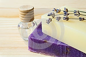Close-up of handmade soap bars, lavender flowers and a bottle of lavender oil.