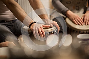 Close up of hands on african drums, drumming for a music therapy, therapy by drums