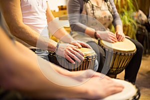 Close up of hands on african drums, drumming for a music therapy, therapy by drums