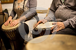 Close up of hands on african drums, drumming for a music therapy, therapy by drums