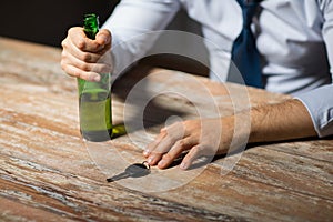 Close up of hands with alcohol and car key