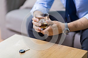 Close up of hands with alcohol and car key