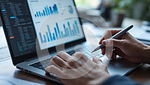 Close-up of hands analyzing financial graphs and spreadsheets on a laptop, symbolizing business analytics