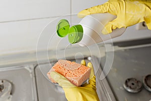 Extruding the detergent onto the sponge, close-up photo