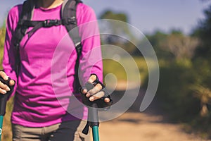 Close up of hands backpacking Asian woman holding trekking pole,Camping hiking concept