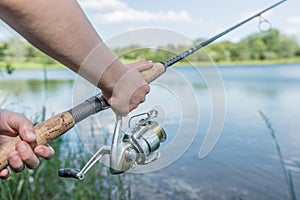 Close-up of hands of a boy with a fishing rod