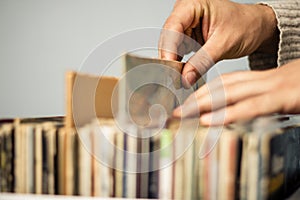 Close up on hands browsing record store