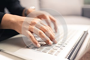 Close up hands of business man using laptop computer working from home, new normal social distancing, work from home concept