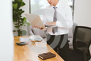 Close up of hands of business man working on laptop.Blank screen