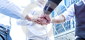 Close up on hands of business people join together on unity concept