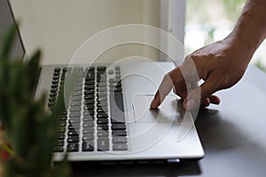 Close up of a hands business person using a laptop computer to work at home