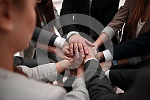 Close-Up of hands business team showing unity with putting their hands together.