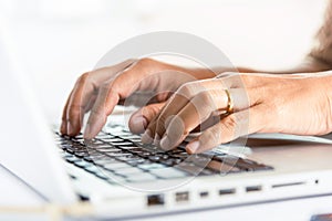Close up Hands of business woman over laptop keypad during working at desk