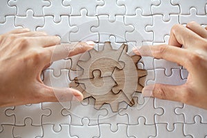 Close up of hands business women connecting jigsaw puzzleon, Teamwork workplace success and strategy concept