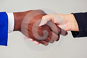 Close up hands of businessman and businesswoman handshaking in office on white background in studio shot. interethnic