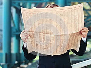 Close up of the hands of the businessman with a newspaper