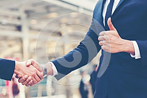 Close up hands businessman and partner working of business people join hand and handshake together and start up work.