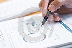 Close-up of hands Businessman reading and writing with pen signing contract over document for Completing Application Form at work