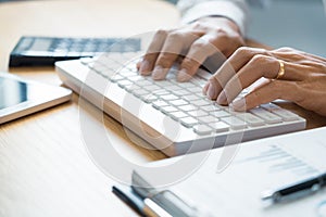 Close-up of hands Businessman reading and writing with pen signing contract over document for Completing Application Form at work