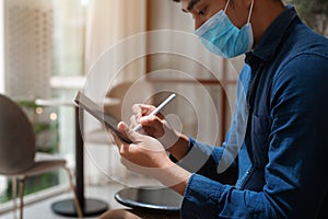 Close up hands Businessman using tablet connecting wifi at cafe with working in the morning