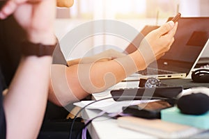 Close up hands on businessman working using smartphone and laptop on table workspace with sunlight. business working background