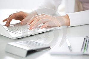 Close-up of hands of businesswoman typing on a laptop