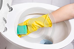 Close-up of hands  cleaning toilet