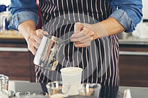 Close up hands coffee barista man make hot cup espresso shot from coffee machine. Cappuccino with milk in italian coffee shop cafe