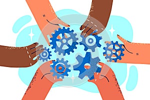 Close-up hands of company employees with variety of gears for concept of teamwork and collaboration