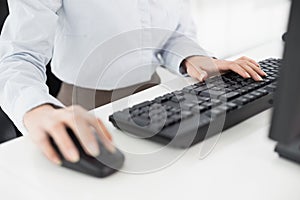 Close up of hands computer keyboard and mouse