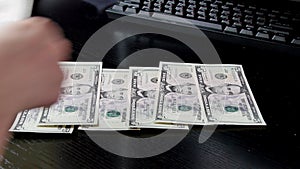 Close up of hands counting five dollar bills. UltraHD footage