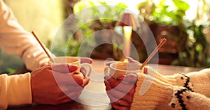 Close-up of the hands of a couple in love sitting at a table in a cafe