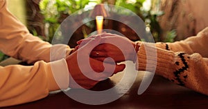 Close-up of the hands of a couple in love sitting at a table in a cafe