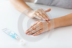 Close up of hands with cream or therapeutic salve