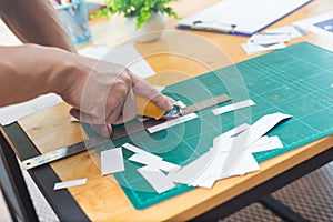 Close up of hands cutting paper