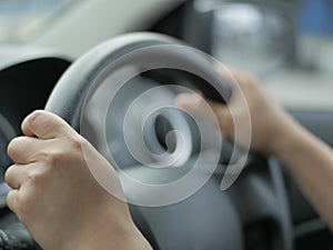 Close up of Hands Driving Car Concept