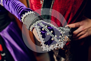 Close Up Hands Of Elder Georgian Man In National Clothes. Culture Of Georgia Country. On His Belt Dagger Hanging.