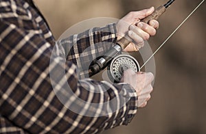 Close up of hands on fishing rod