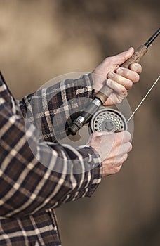 Close up of hands on fishing rod