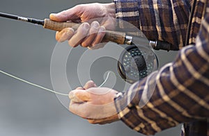 Close up of hands on fishing rod