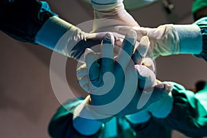 Close up hands group and teamwork of surgeons in hospital operating room.