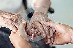 Close up hands of helping hands for elderly home care.