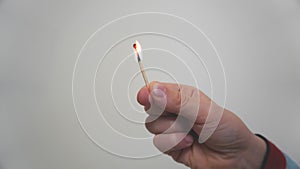 A child's hand with a burning match