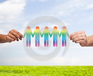 Close up of hands holding paper chain gay people