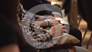 Close-up of Hands holding pens at the conference. Stock. Training, Business, Presentation