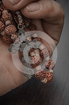 Close-up of hands holding Rosary beads