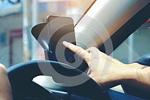 Close-up of hands holding smartphone in the car interior, blank