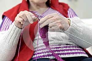 Close-up on hands of knitting senior woman