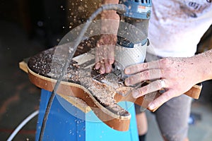 Close Up on Hands of Luthier Building a Wood Handmade Guitar photo
