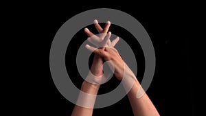 Close up of the hands of a male teenager yawning stretching hands and feeling lazy isolated on black background.Concept of Sunday